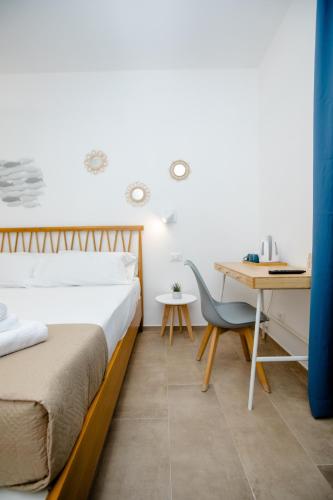 a bedroom with a bed and a desk at Kaary BellaVita Superior Room in Marzamemi