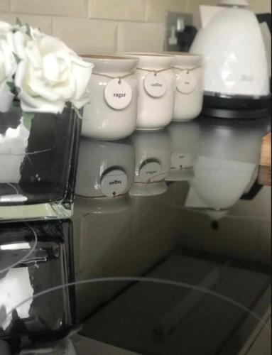 a row of white dishes sitting on a counter at Chester City Apartments - With free parking in Chester