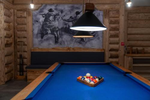 a billiard table in a room with a lamp at Malinowy Potok in Białka Tatrzanska