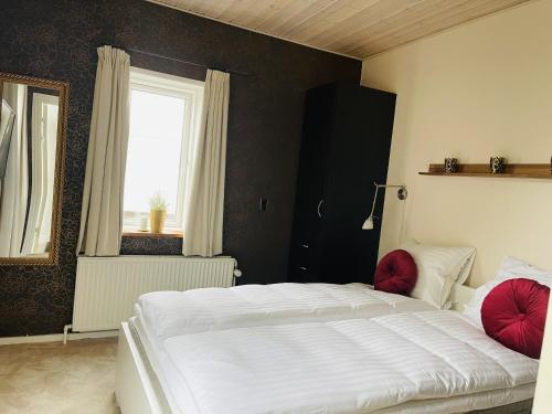 a bedroom with a white bed and a window at aday - Private room - Frederikshavn Center in Frederikshavn