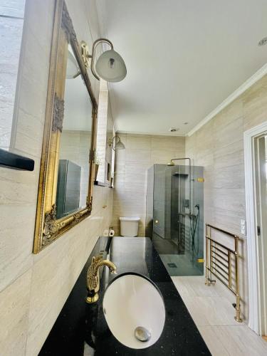 a bathroom with a sink and a glass shower at aday - Private room - Frederikshavn Center in Frederikshavn