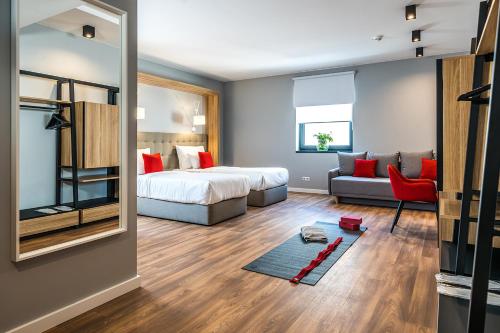 a bedroom with a bed and a living room at Up Hotel Budapest in Budapest