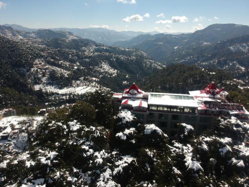 a building on top of a snow covered mountain at WelcomHeritage Elysium Resort & Spa in Shimla