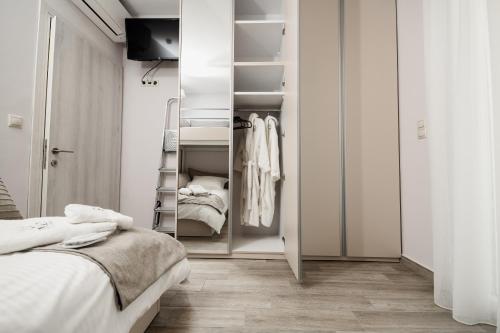 a bedroom with a closet with two beds at Onar Village Luxury Apartments in Kavala
