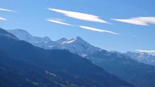 a view of a mountain with clouds in the sky at Hüttenzauber in Taxenbach