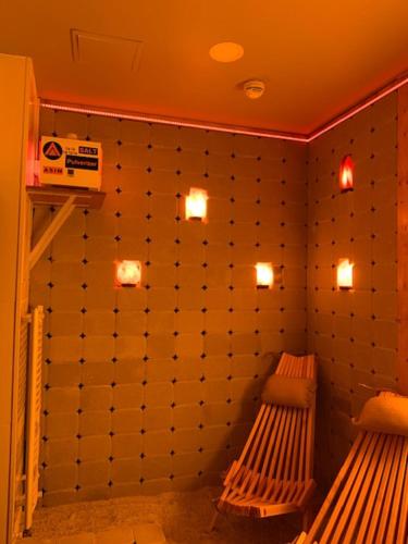 a room with two benches on a wall with lights at HOTEL CARPAT INN in Azuga
