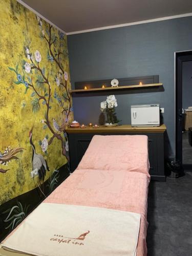 a bedroom with a bed with a floral wall at HOTEL CARPAT INN in Azuga