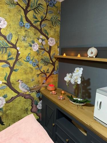 a room with a wall with a floral wallpaper at HOTEL CARPAT INN in Azuga