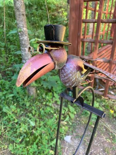 a bird with a top hat on a stand at HOTEL CARPAT INN in Azuga