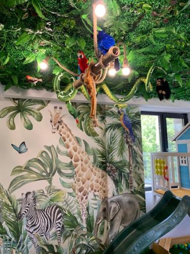 a room with a painting of animals on the wall at HOTEL CARPAT INN in Azuga
