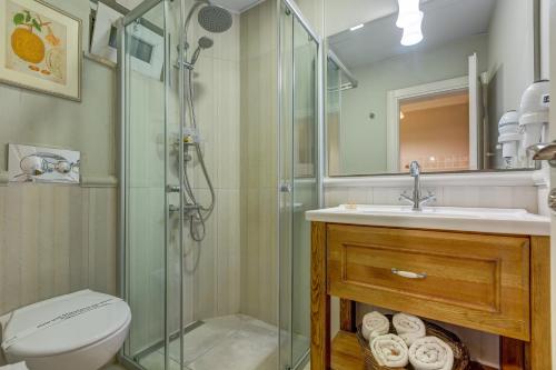 a bathroom with a shower and a toilet and a sink at Gurel Garden House in Kucukkuyu