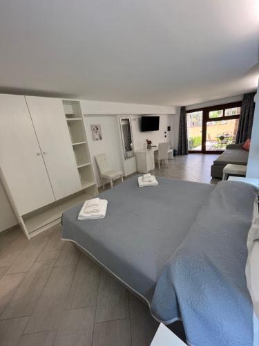 a bedroom with a large bed and a living room at Residenza Azzurra in Tropea