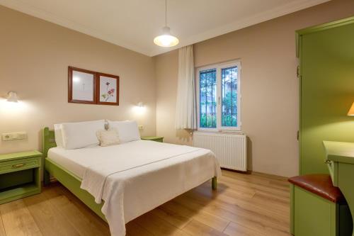 a bedroom with a white bed and a window at Gurel Garden House in Kucukkuyu