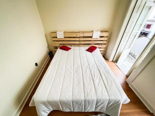 a white bed in a room with a window at Sweet Love Family Budget in Coimbra