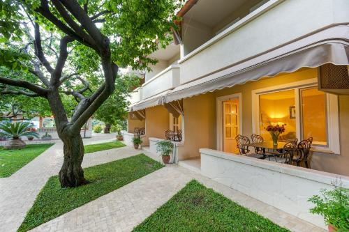 a house with a tree and a table and chairs at Gurel Garden House in Kucukkuyu