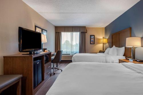 a hotel room with two beds and a flat screen tv at Comfort Inn Horsham - Philadelphia in Horsham