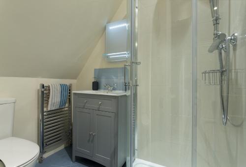 a bathroom with a shower and a sink at Upper End House in Shipton under Wychwood