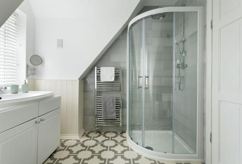 a bathroom with a shower and a sink at Upper End House in Shipton under Wychwood