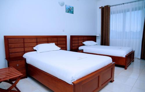 Säng eller sängar i ett rum på Greenyard Beach Hotel