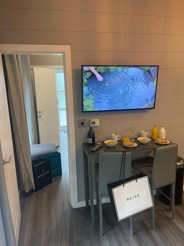 a dining room with a table and a tv on the wall at P78 - Studio Pod with Hot Tub in Bethesda
