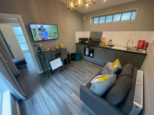 a living room with a couch and a kitchen at P78 - Studio Pod with Hot Tub in Bethesda