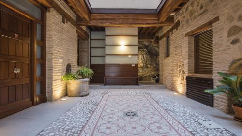 an entrance to a house with a door and a tile floor at Capricho Toledano in Toledo