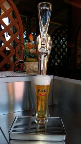 a glass of beer is sitting on a table at Drini Hotel in Durrës
