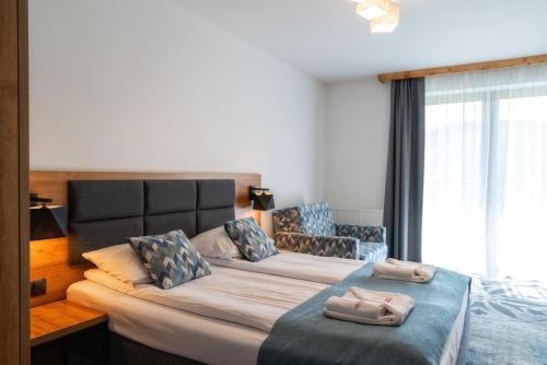 a bedroom with two beds with pillows on them at Malinowy Potok in Białka Tatrzanska