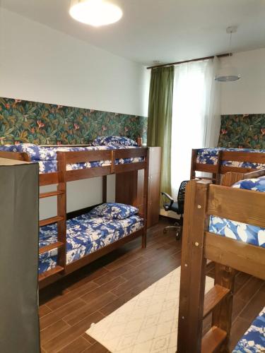 a room with four bunk beds and a window at Vintage Downtown Rooms in Braşov
