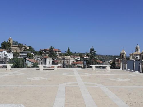 a large parking lot with benches in front of a city at Casa Olga in Pianella