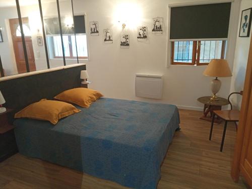ein Schlafzimmer mit einem Bett mit einer blauen Decke darauf in der Unterkunft Thuir: superbe appartement in Thuir