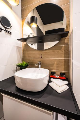 a bathroom with a large white sink on a black counter at Up Hotel Budapest in Budapest