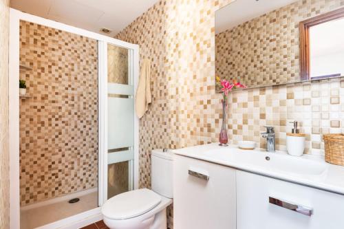 a bathroom with a toilet and a sink and a shower at Villa Matias Maria by Villa Plus in Cala en Blanes