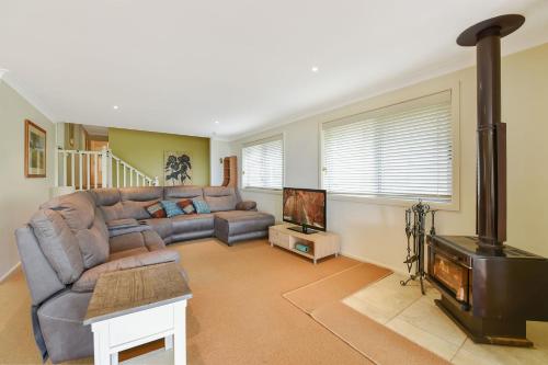a living room with a couch and a flat screen tv at Aisling View in Blackheath