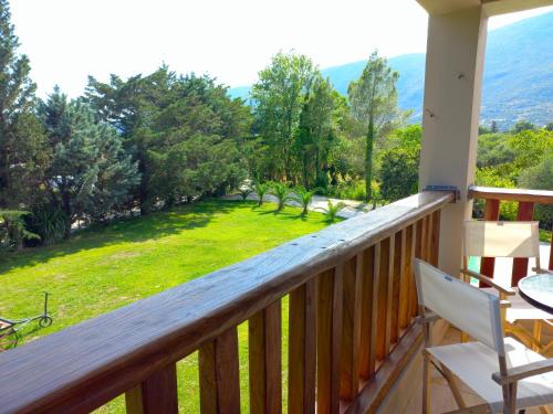 a balcony with a view of a yard at Platanos in Vasiliki