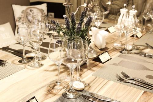 a table with wine glasses on top of it at Hotel Nove in Svishtov