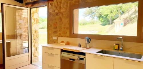 a kitchen with a sink and a window at Recientemente restaurada, ideal para familias! in Cabanellas