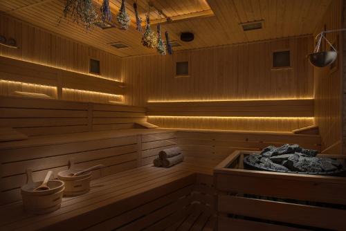 a sauna with a tub with lights in it at Wine & SPA Hotel Chukara in Tryavna