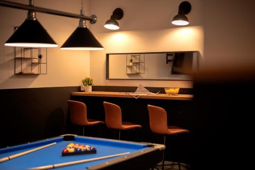 a pool table in a bar with chairs and lights at NEW! ReLux - ZF Hvar in Hvar