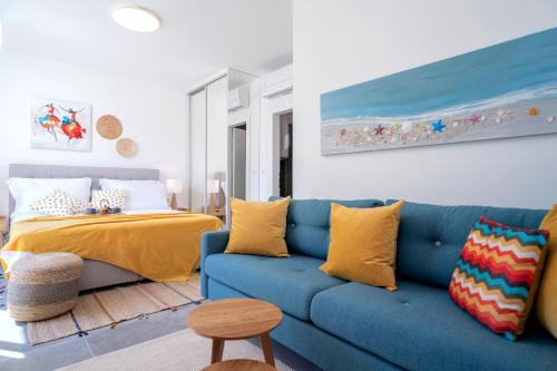 a living room with a blue couch and a bed at NEW! ReLux - ZF Hvar in Hvar