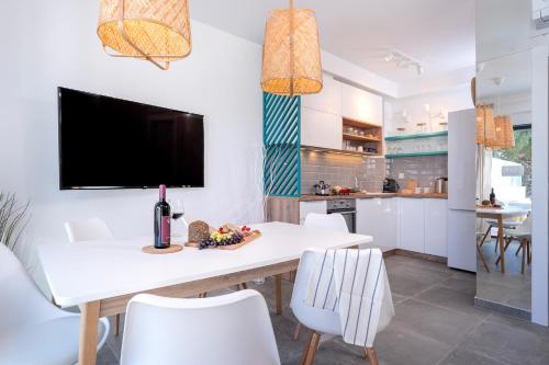 a kitchen and dining room with a white table and chairs at NEW! ReLux - ZF Hvar in Hvar