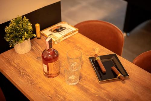 a wooden table with a bottle of alcohol and a glass at NEW! ReLux - ZF Hvar in Hvar