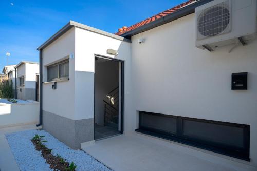a white house with a large sliding glass door at NEW! ReLux - ZF Hvar in Hvar