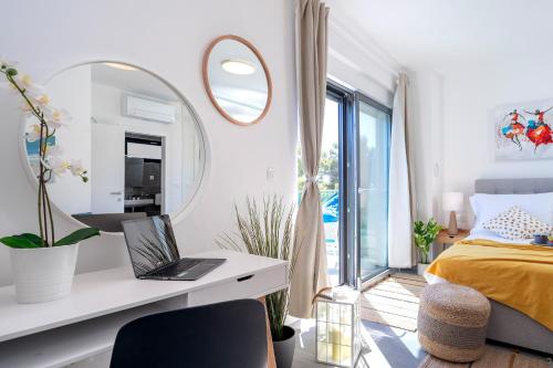 a bedroom with a bed and a desk with a laptop at NEW! ReLux - ZF Hvar in Hvar