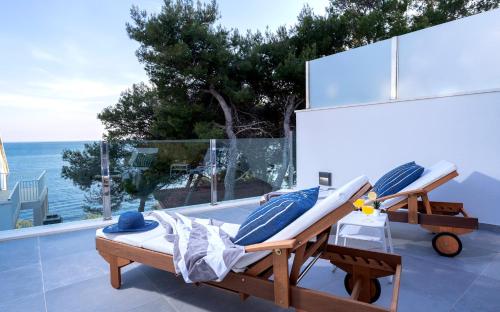 a bed on a balcony with a view of the ocean at NEW! ReLux - ZF Hvar in Hvar