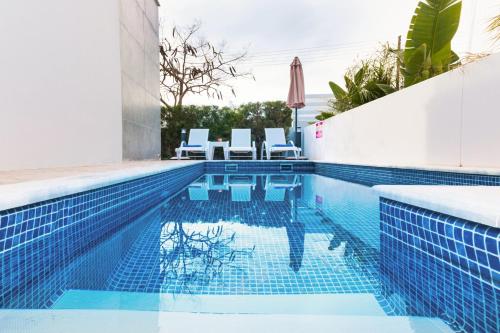 a swimming pool with blue tile in a house at Villa Katherine - Nissi Beach Area in Ayia Napa