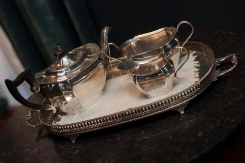 a tray with two silver containers on a table at The Coleridge Boutique Hotel In Valletta in Valletta