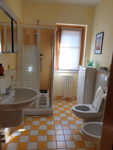 a bathroom with a sink and a toilet at Lake View Camelia Room at Villa Isabella Stresa Retreat Ages 6 plus in Stresa