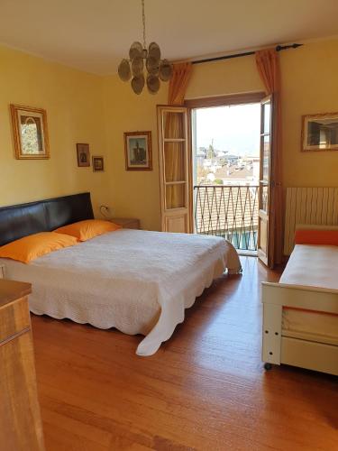 a bedroom with a large bed and a balcony at Lake View Camelia Room at Villa Isabella Stresa Retreat Ages 6 plus in Stresa