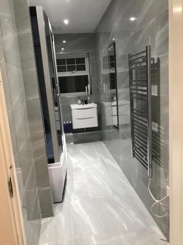 a bathroom with a shower and a sink and a mirror at 2 Double Bedroom Apartment in Edgware, London in Edgware